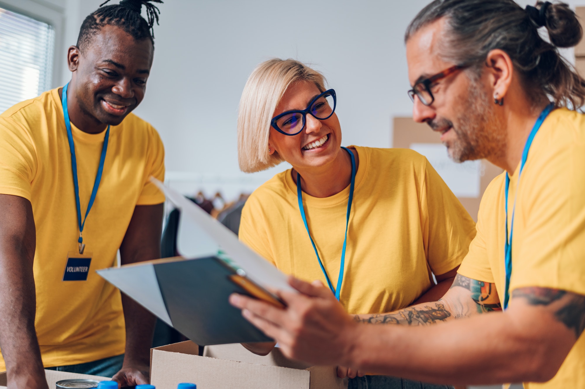 Group of multiracial volunteers working in community charity donation center